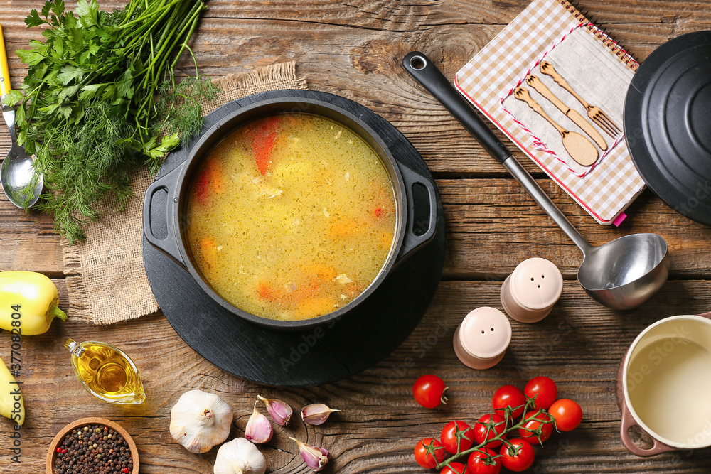 Pot of tasty rice soup on table