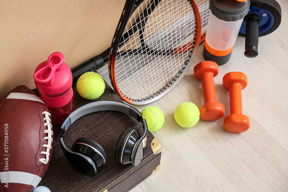 Set of sport equipment on floor near color wall