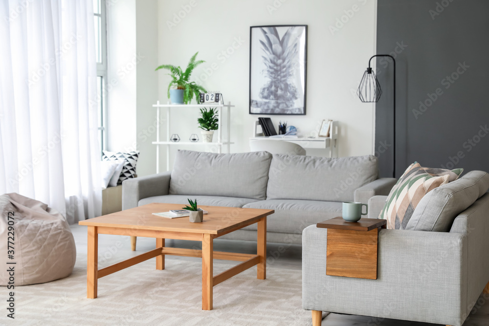 Armrest table on sofa in interior of room