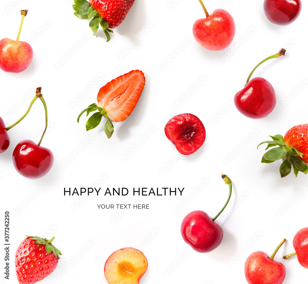 Creative layout made of strawberries and cherry on the white background.Happy and healthy. Flat lay.