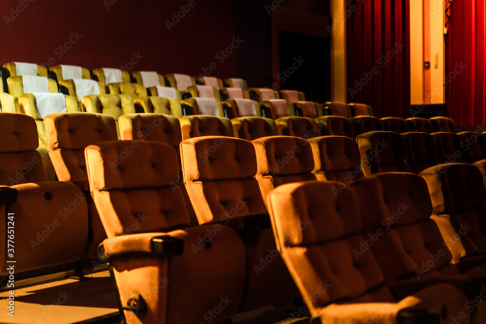 A row of yellow seat with popcorn on chair in the movie theater