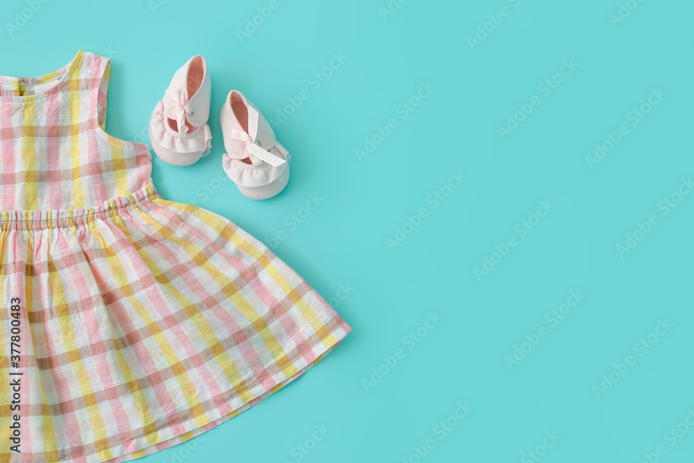 Stylish baby clothes on color background