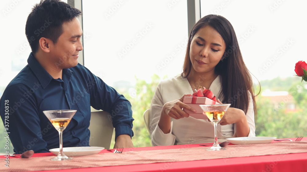 浪漫的情侣在餐厅给爱人送礼物。幸福的情侣生活方式。