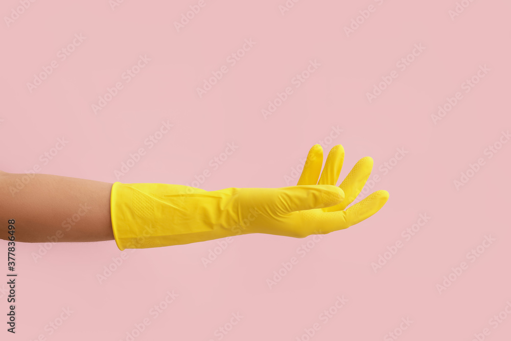 Hand in rubber glove on color background