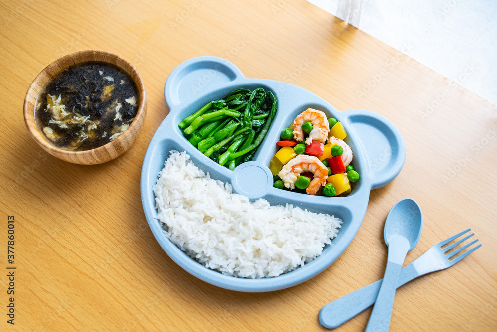 A plate of nutritious childrens meal on the table