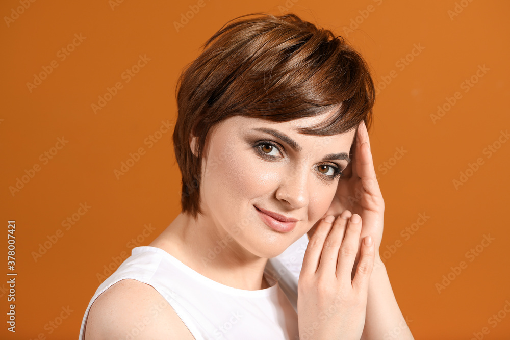 Young woman with beautiful short hair on color background