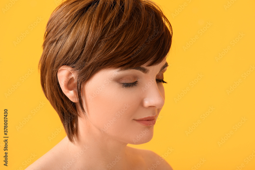 Young woman with beautiful short hair on color background