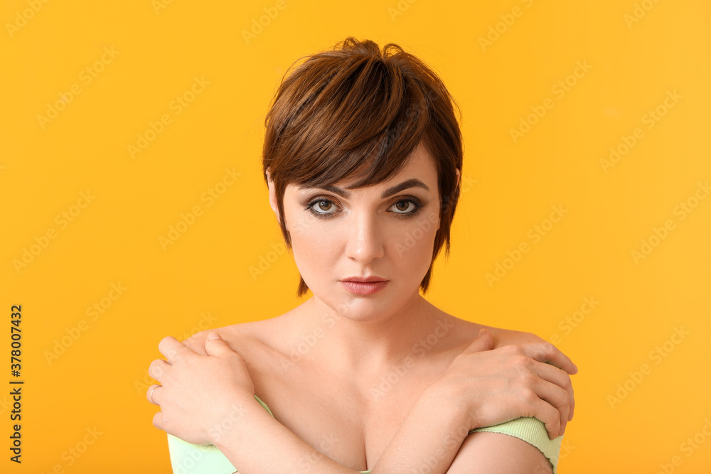 Young woman with beautiful short hair on color background