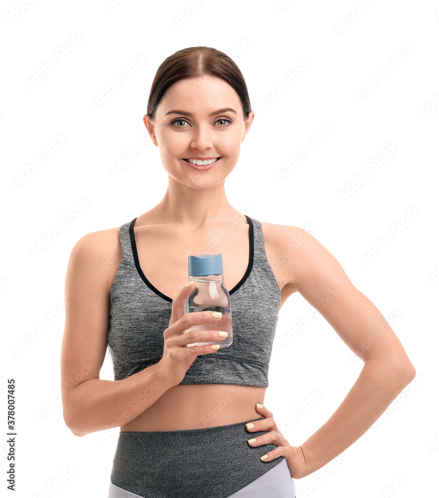 Sporty young woman with bottle of water on white background