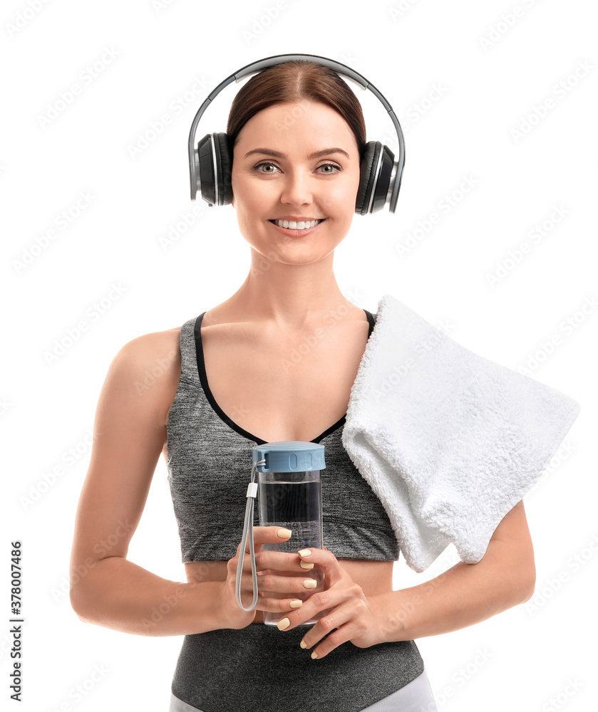 Sporty young woman with bottle of water on white background