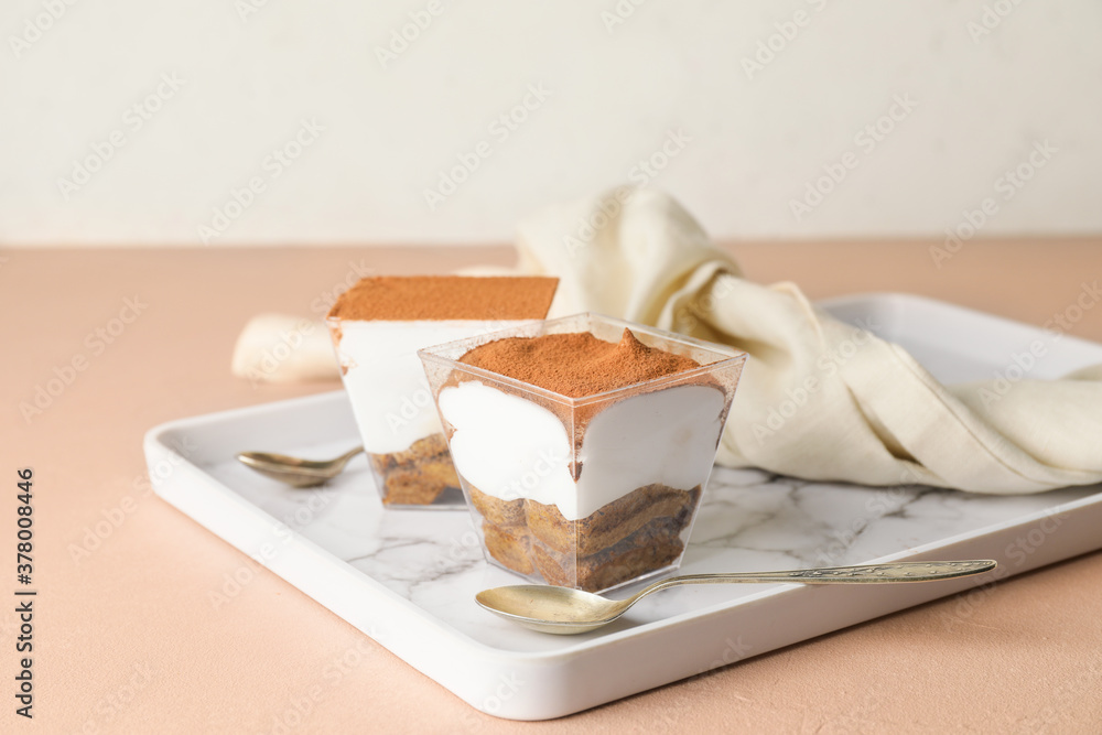 Sweet tasty tiramisu on table