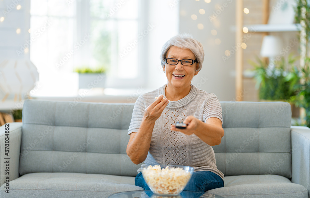 Senior woman watching TV