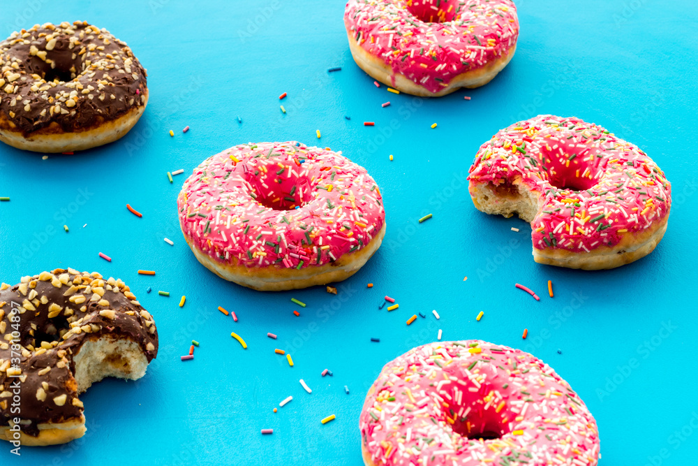 Colorful donuts close up, glazed and sprinkles bakery