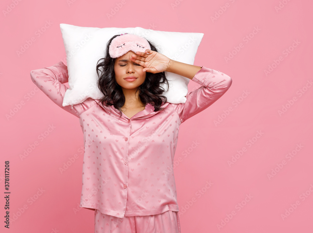 Sleepy ethnic female with pillow.