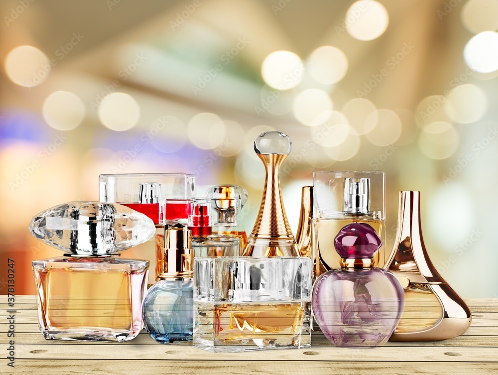 Collection of colored glass perfume bottles on the desk