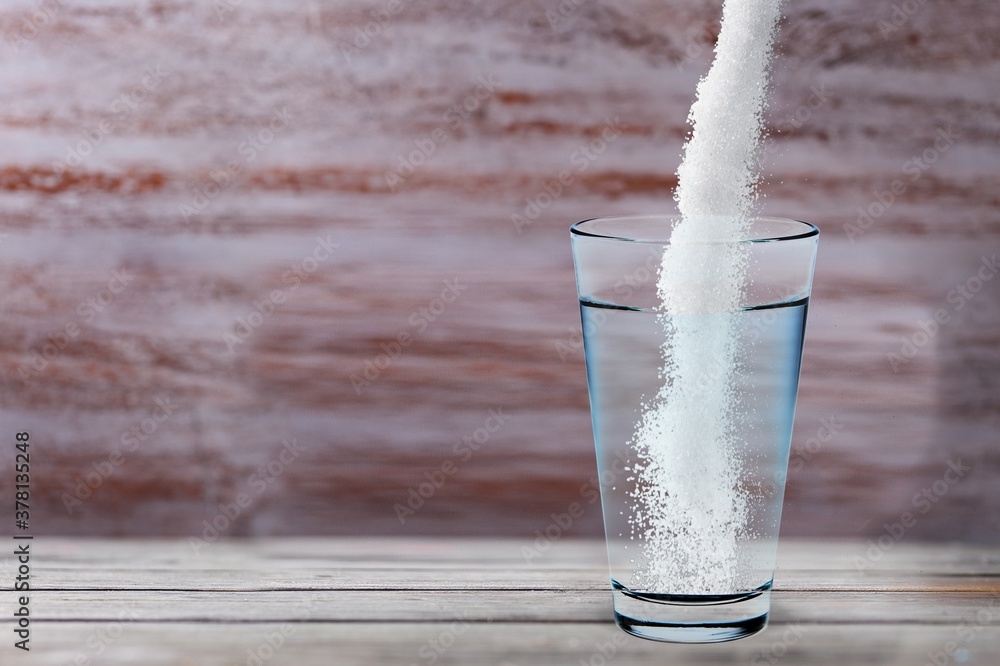 Powder being poured into glass with water