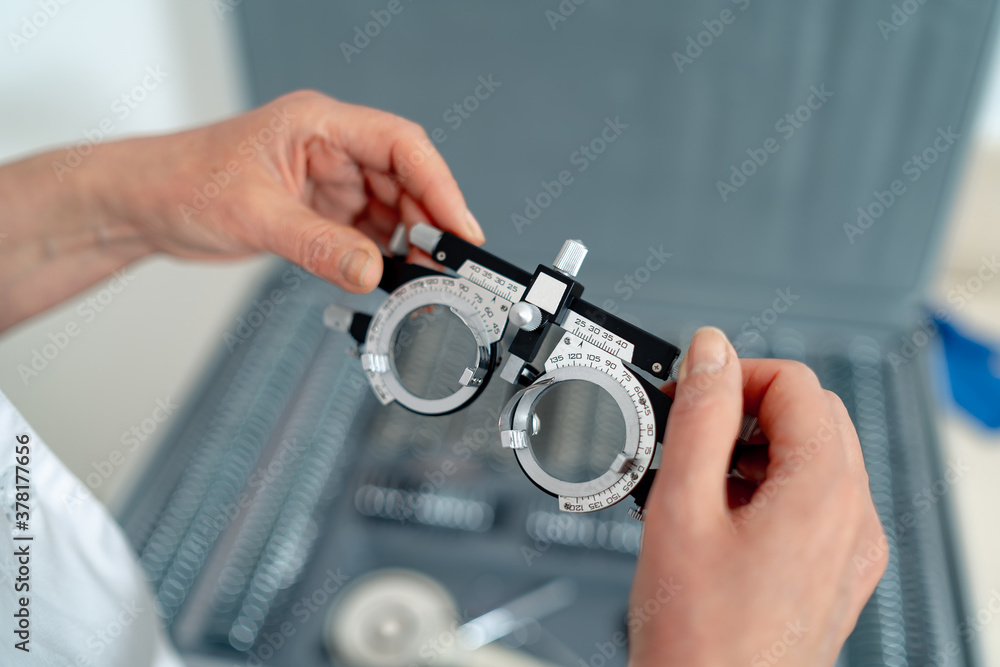 Vision care equipment. Ophthalmology testing spectacles in hands. Selective focus.