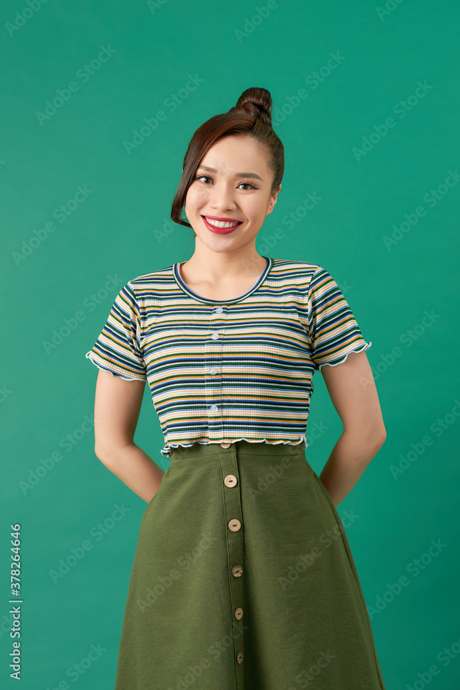 Smiling young woman over green