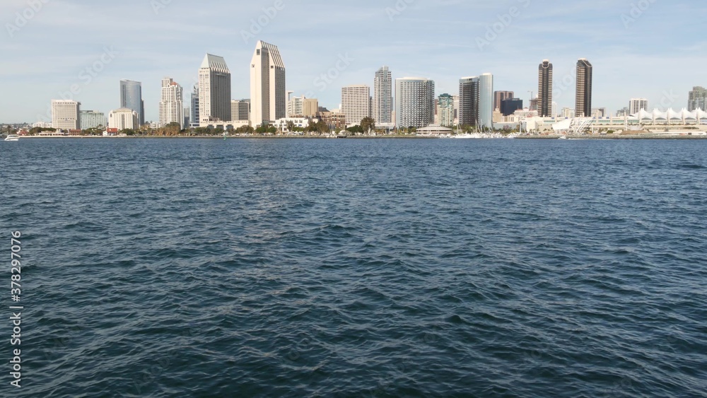 Metropolis urban skyline, highrise skyscrapers of city downtown, San Diego Bay, California USA. Wate