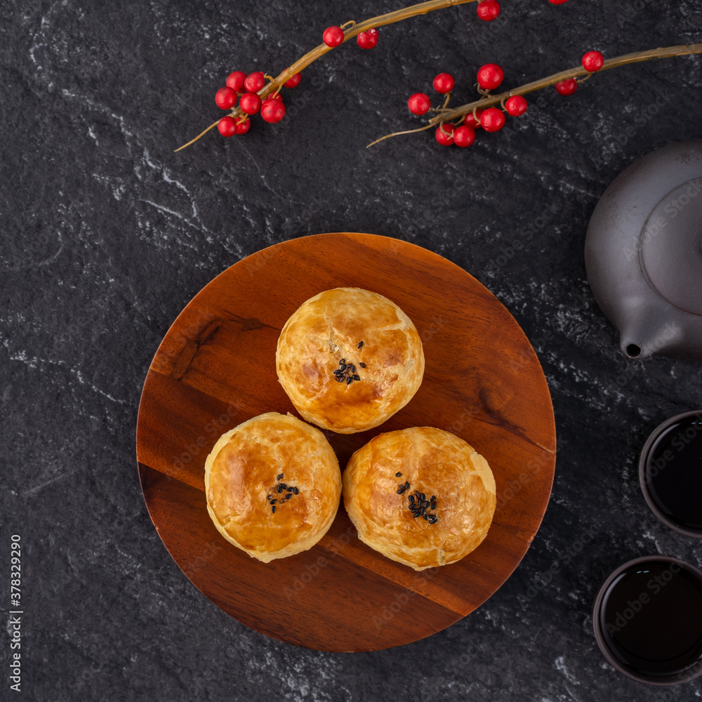 Moon cake yolk pastry, mooncake for Mid-Autumn Festival holiday, top view design concept on dark woo