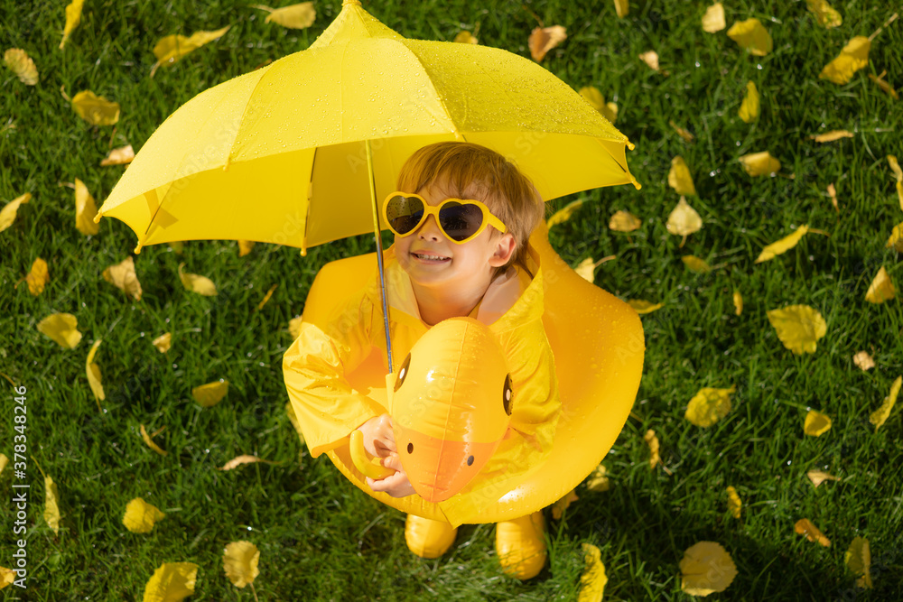 Happy child having fun outdoor in autumn park