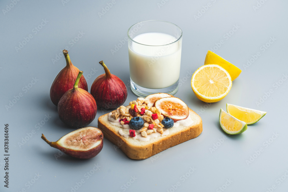 A healthy western breakfast with figs and toast and oatmeal.A western breakfast with fruit and milk