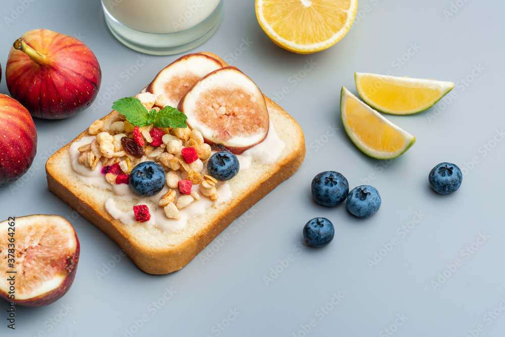 A healthy western breakfast with figs and toast and oatmeal.A western breakfast with fruit and milk