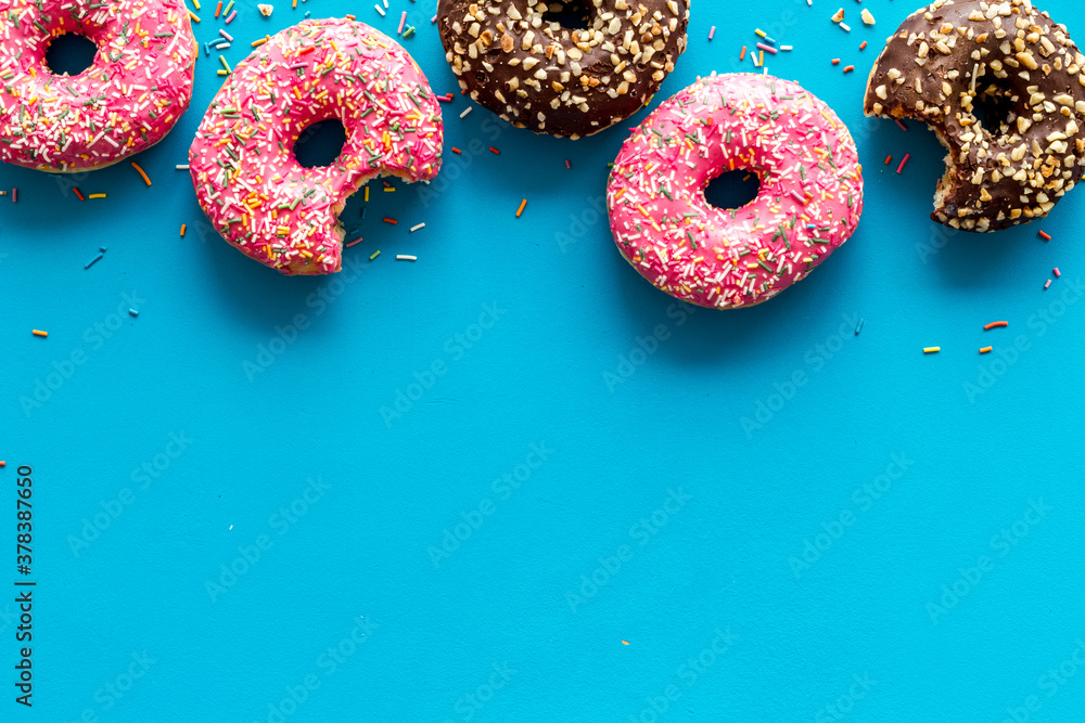 Top view of colorful glazed donut swith sprinkles, copy space