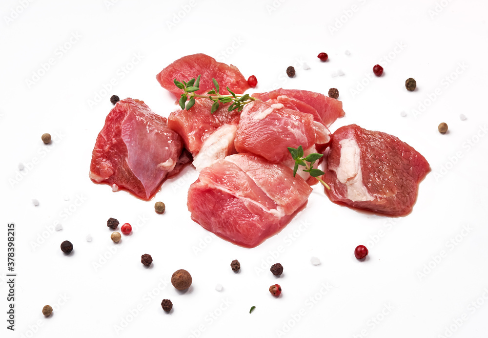 Sliced mutton meat with thyme herb and mix peppers isolated on white. Pieces of raw mutton meat.