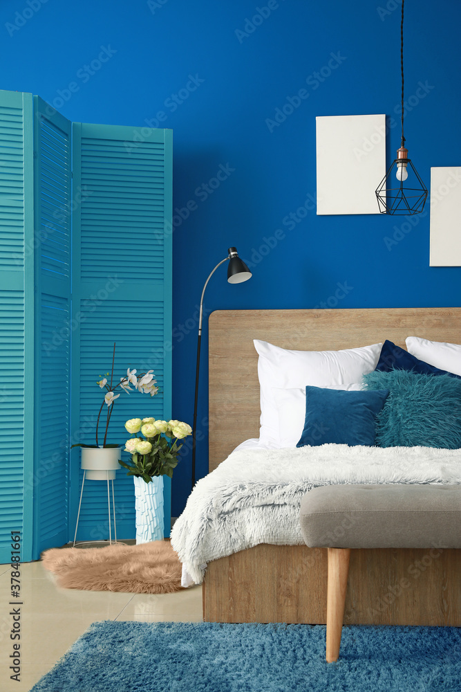 Interior of modern bedroom with blue wall