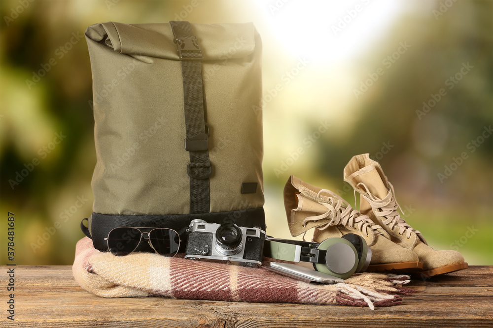 Set of travelers accessories on table against blurred background