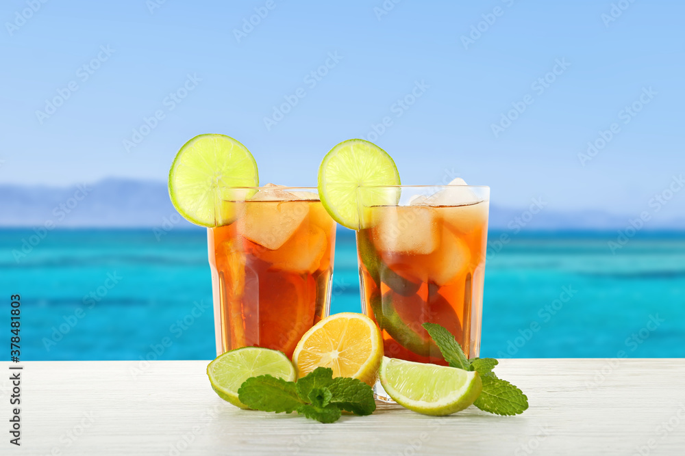 Glasses of tasty cold ice tea on table at sea resort