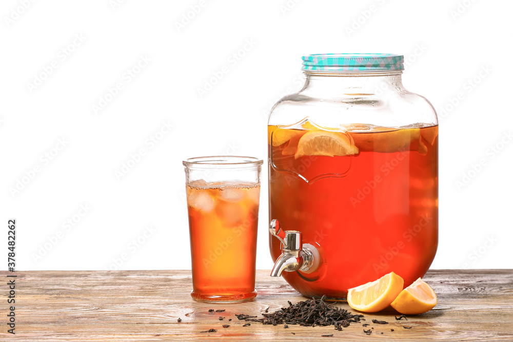 Jar and glass of fresh ice tea on table against white background