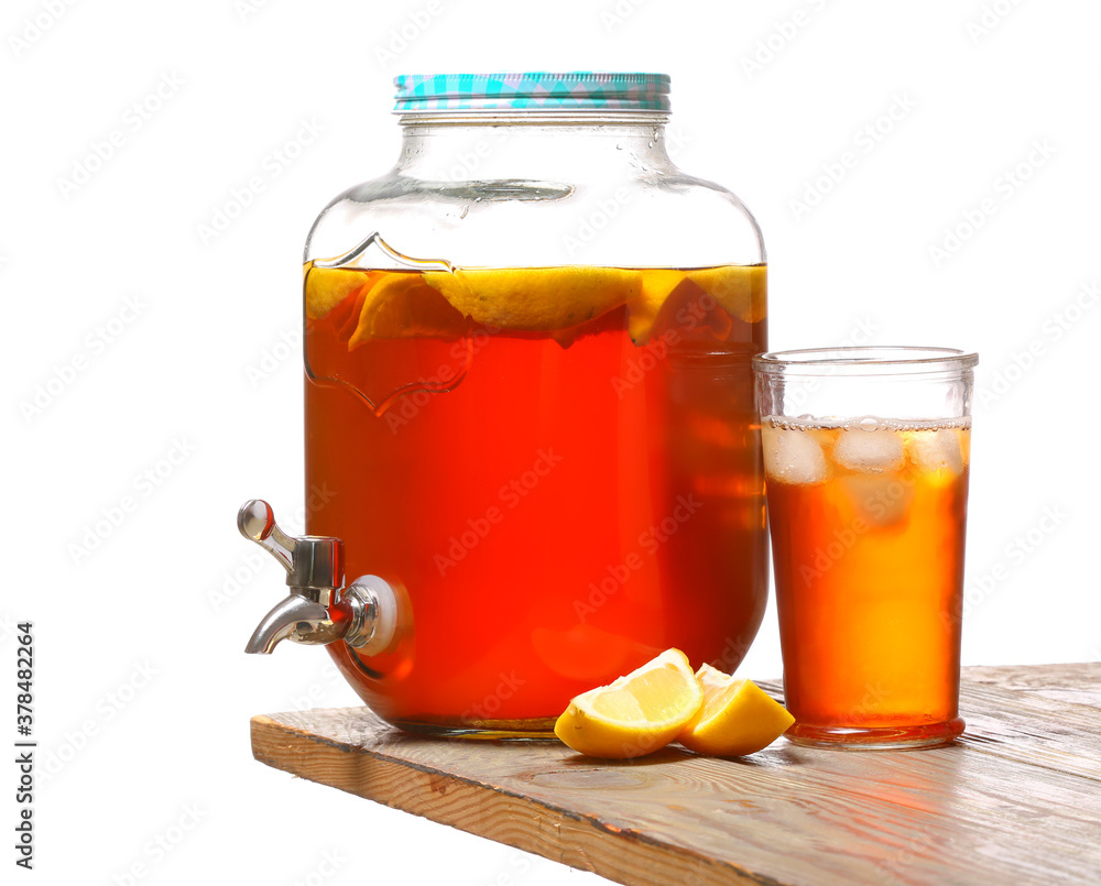 Jar and glass of fresh ice tea on table against white background