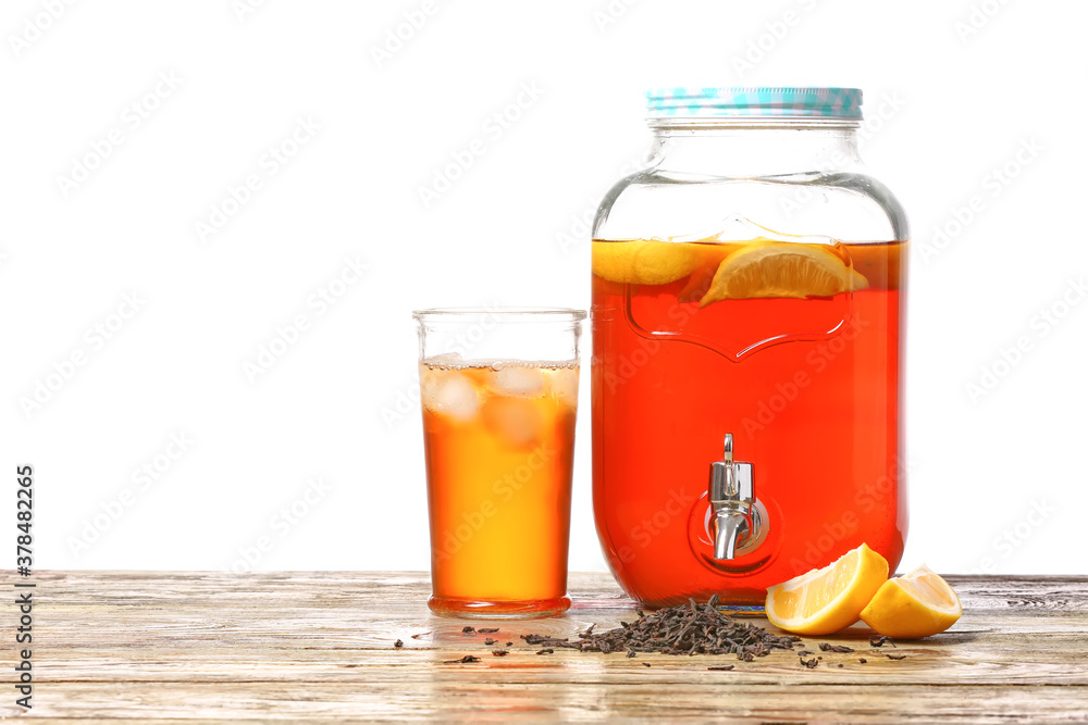 Jar and glass of fresh ice tea on table against white background