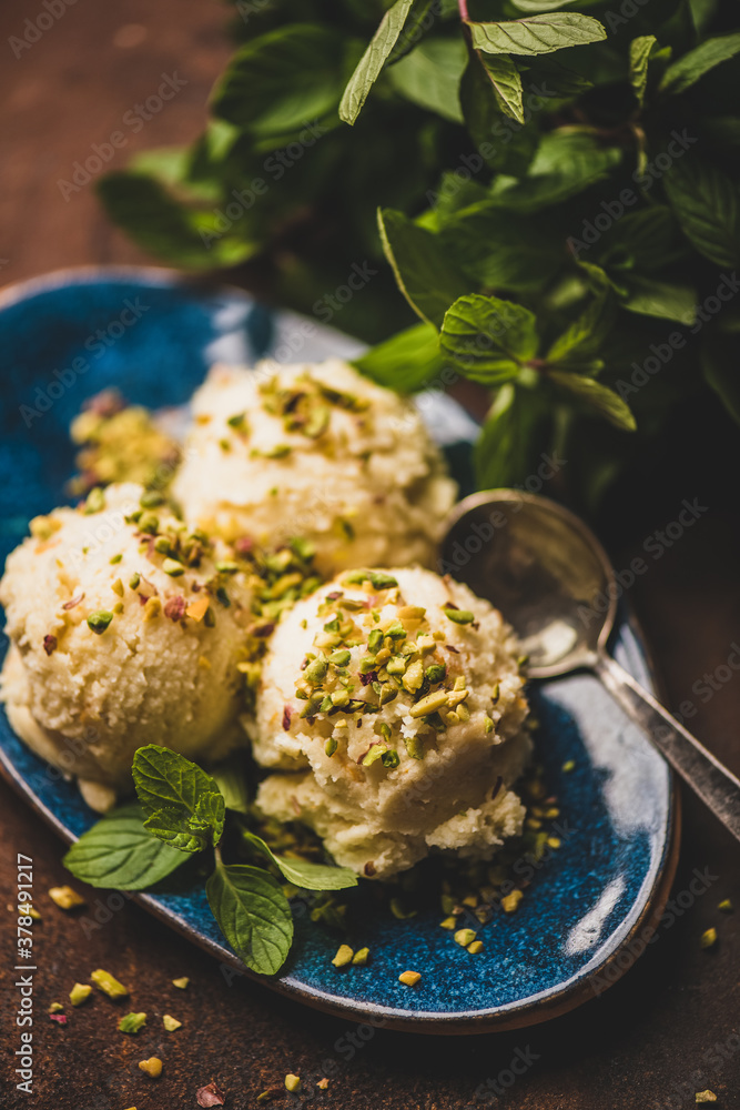 Turkish traditional dessert semolina helva. Scoops of sweet semolina helva with pistachio nuts and f