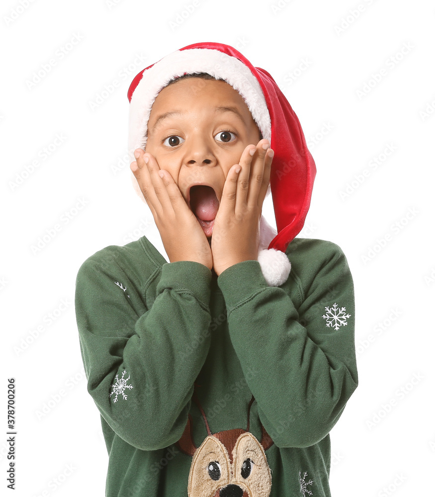 Surprised African-American boy in Santa hat on white background