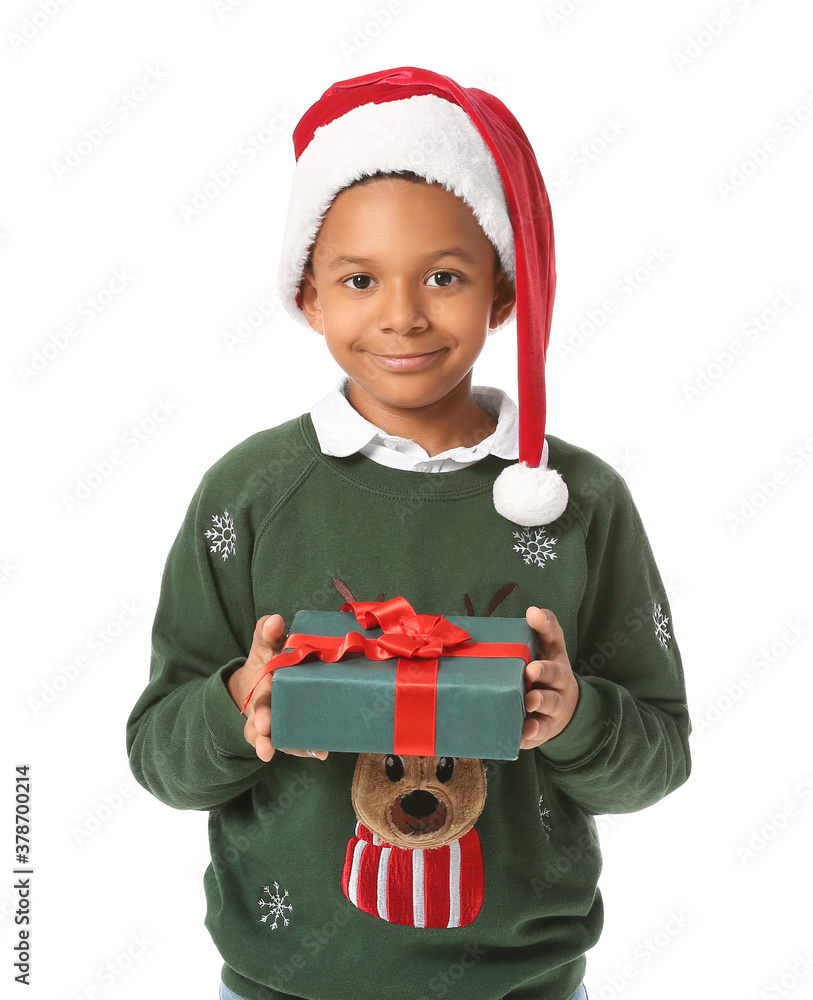 Cute African-American boy in Santa hat and with Christmas gift on white background