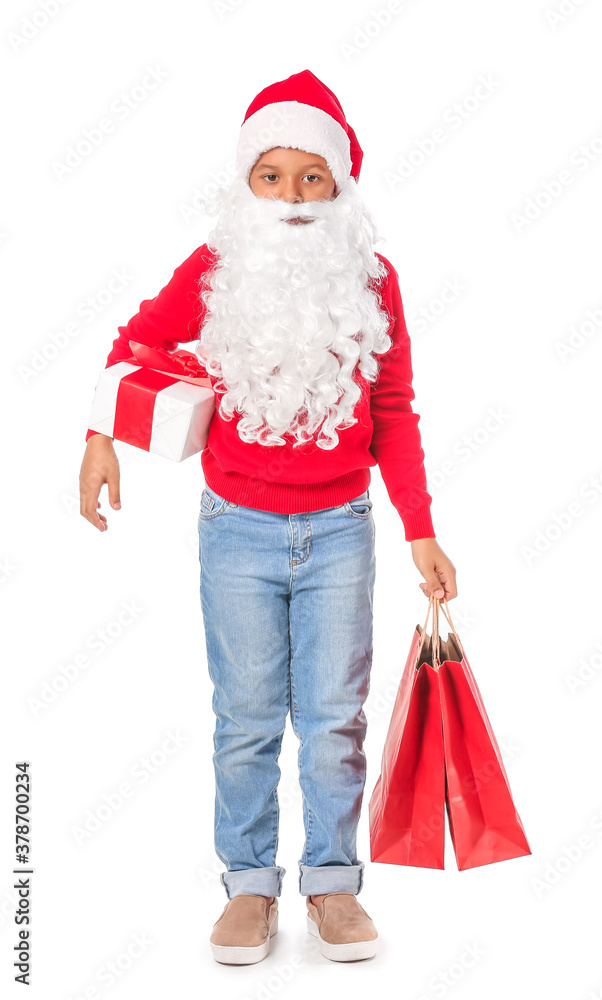 Cute African-American boy in Santa costume and with shopping bags on white background