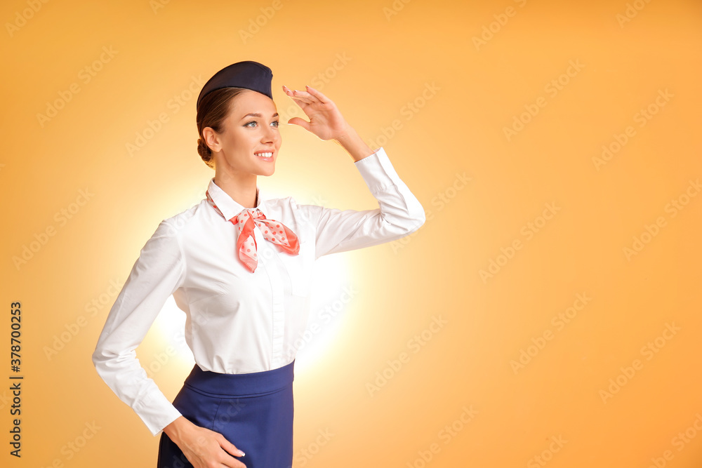 Beautiful stewardess on color background