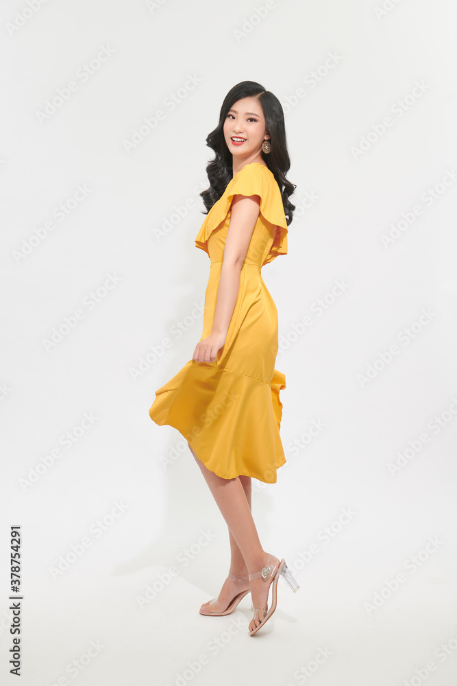 A beautiful girl in a light yellow dress. Charming light style