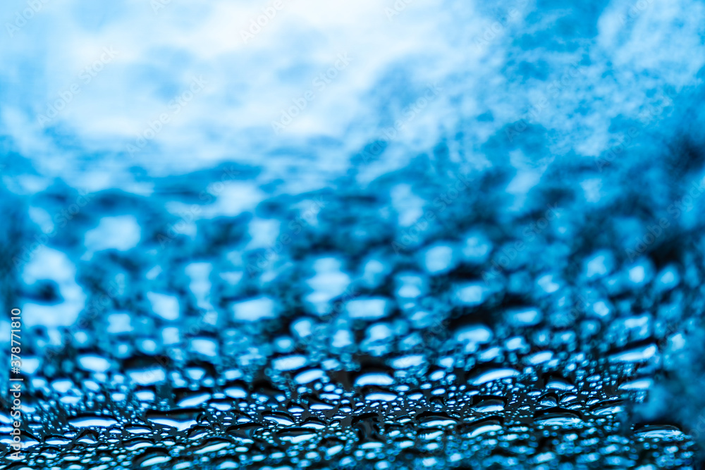 Deep water drops on glass. Selective focus on window with rain drops on it. Close up.