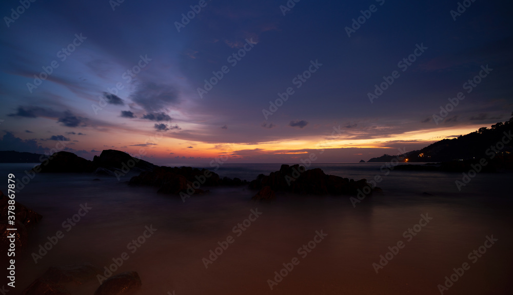 Amazing Beautiful Light of nature Dramatic sky seascape with rock in the foreground in sunset or sun