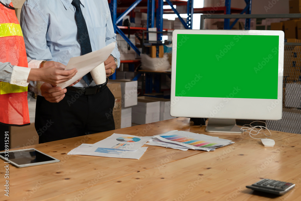 Computer with green screen display in warehouse storage room . Delivery and transportation software 