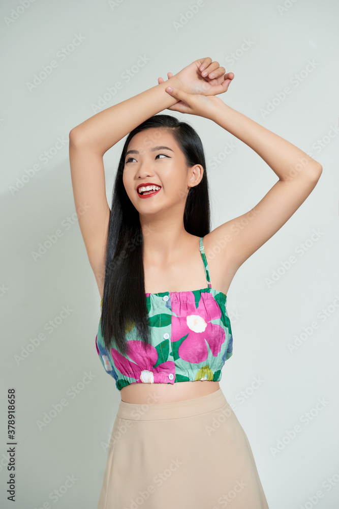 A happy asian woman is very satisfied with her appearance.