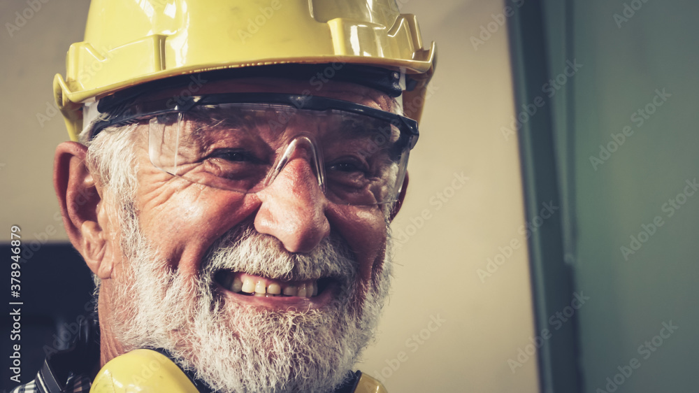 Senior factory worker or engineer close up portrait in factory . Industry and engineering concept .