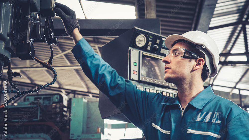 Smart factory worker using machine in factory workshop . Industry and engineering concept.