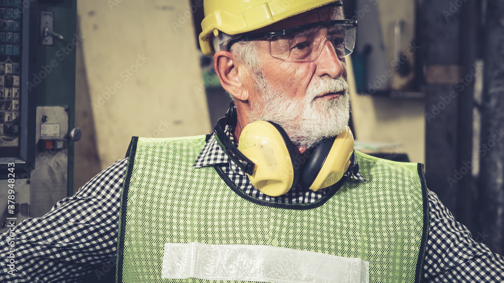 Senior factory worker or engineer close up portrait in factory . Industry and engineering concept .