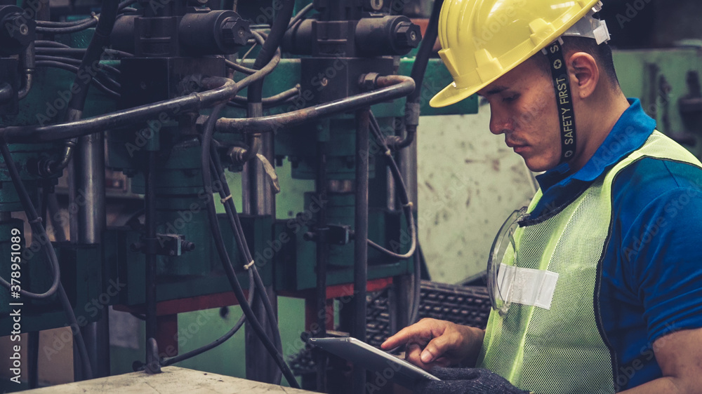 Smart factory worker using machine in factory workshop . Industry and engineering concept.