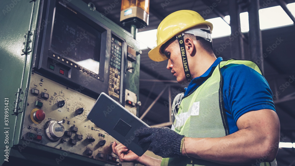 Smart factory worker using machine in factory workshop . Industry and engineering concept.